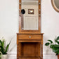 This is a vintage oak hall tree table with mirror, coat hooks & drawer.