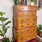 This is a vintage solid wood chest on chest tall boy dresser with seven drawers.