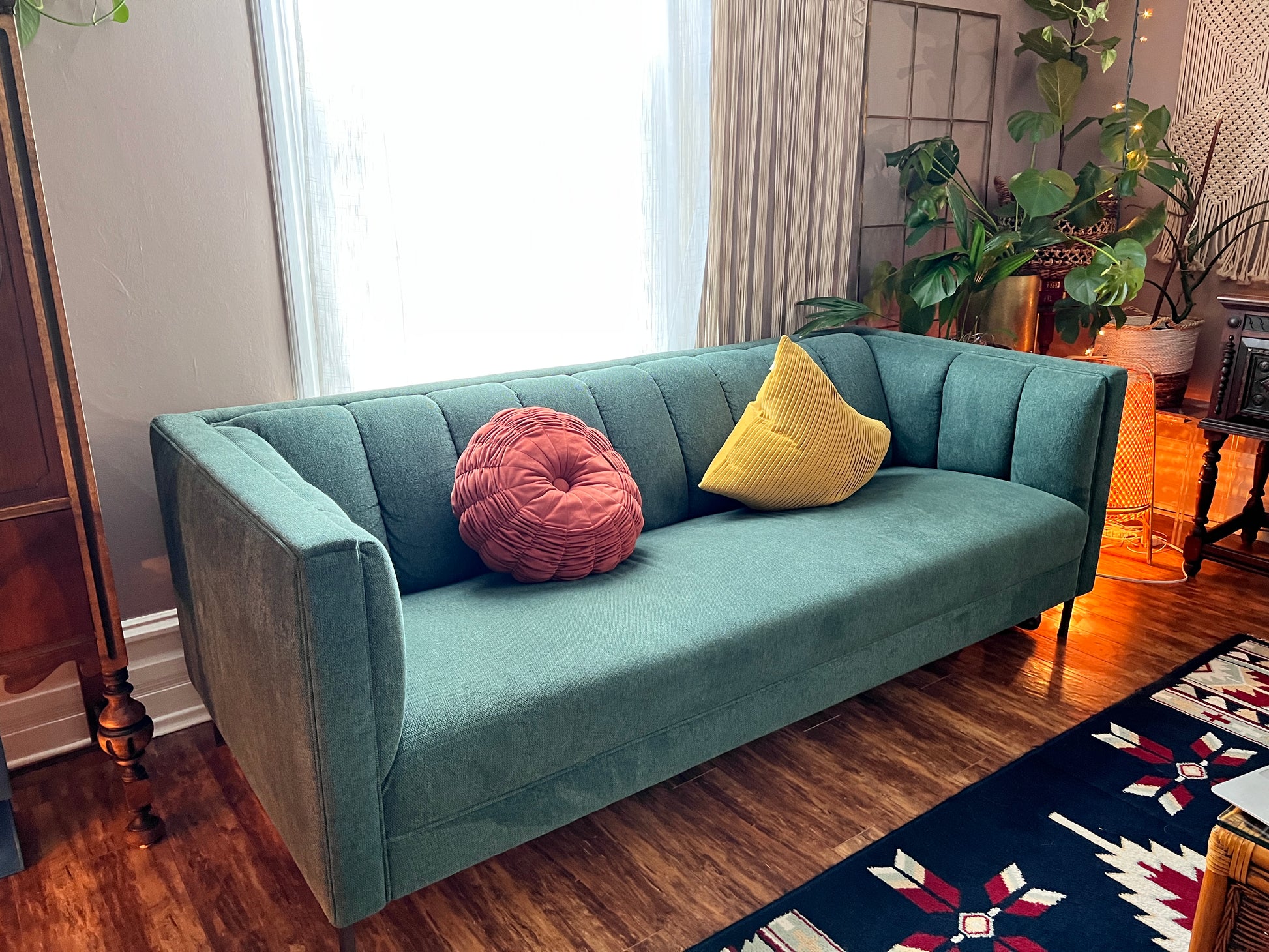 This is a forest green retro mcm style sofa with over stuffed backing.
