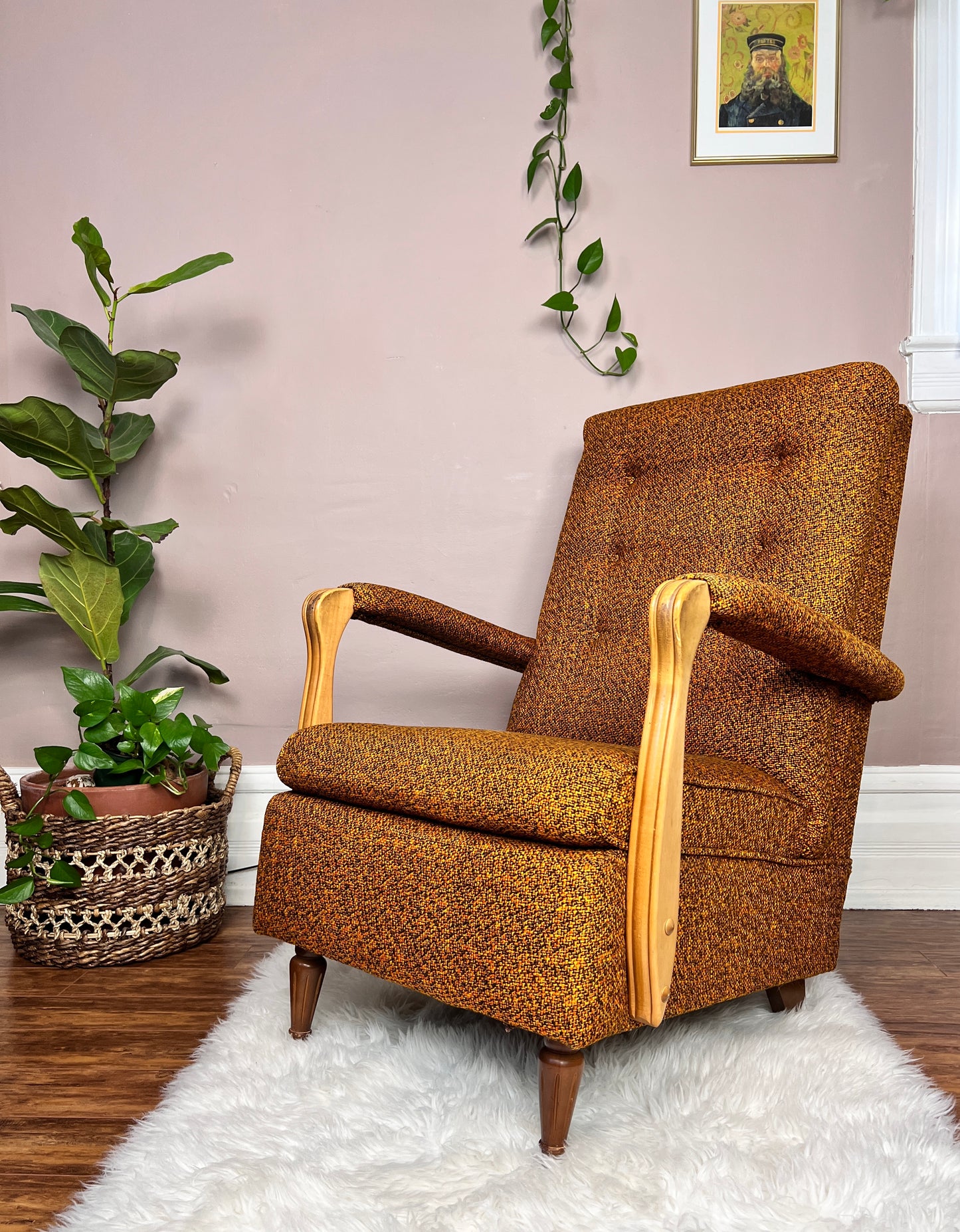 This is a vintage midcentury burnt orange tweed armchair