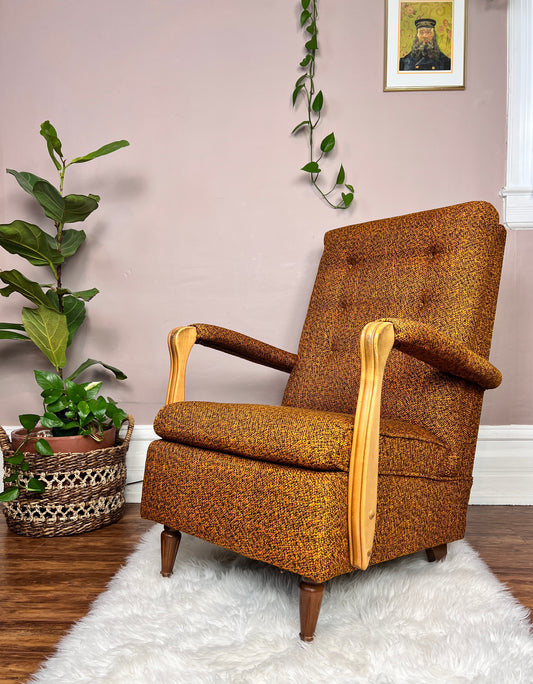 This is a vintage midcentury burnt orange tweed armchair