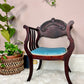 This a antique bentwood armchair with blue velvet seat cushion.