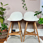 These are retro white egg chair style stools in white plastic and natural wood legs.