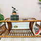 This is a unique rattan coffee table with glass top and curved magazine/record holders on each side.