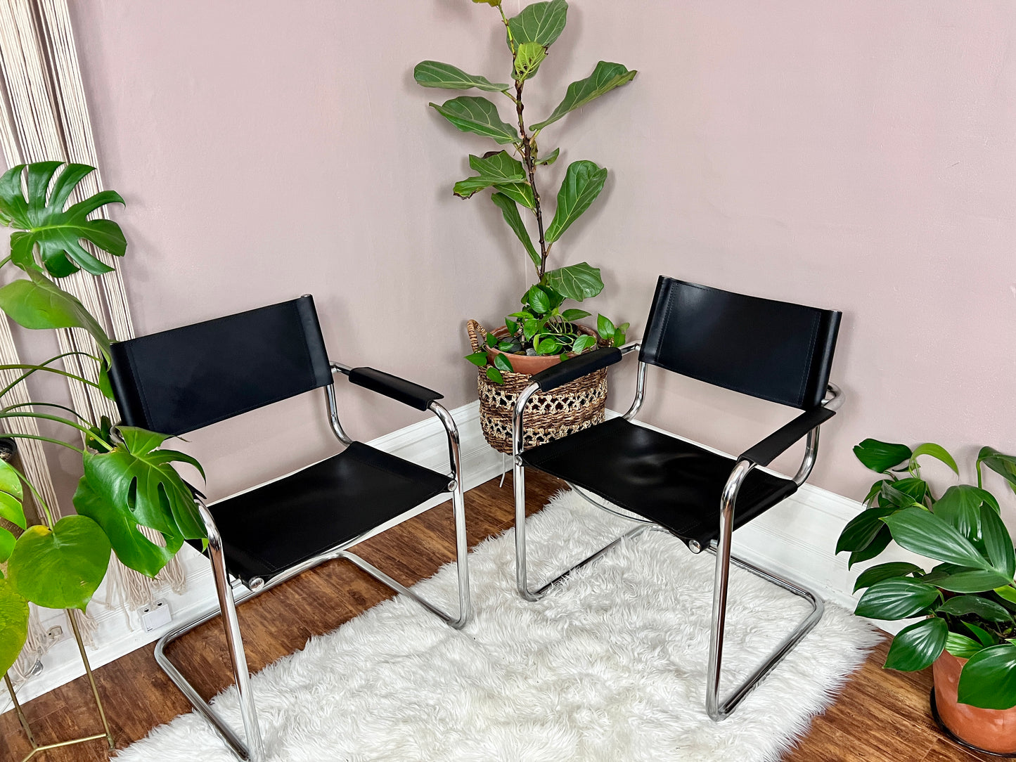 These are mart stam s34 chairs made in italy in the 1980s. They have a silver metal cantilever frame and black leather upholstery.