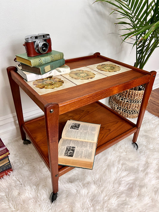 This is a vintage danish teak bar cart with floral pattern 3 tiled inlay.